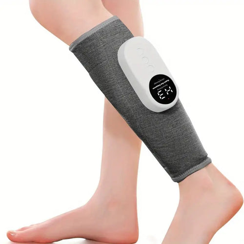 Gray fabric leg massager sleeve with white controller on a person’s calf