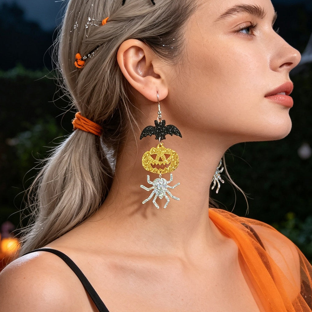 Drop earrings showing black bat and gold glitter pumpkin with silver spider dangles