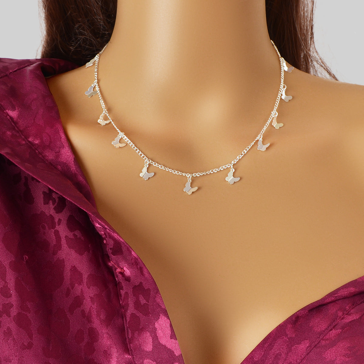 Gold-tone butterfly charm choker necklace with small butterfly pendants