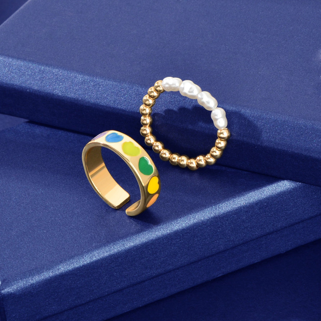 Set of pearl and gold-tone bead elastic heart rings, multicolor enamel and white pearls