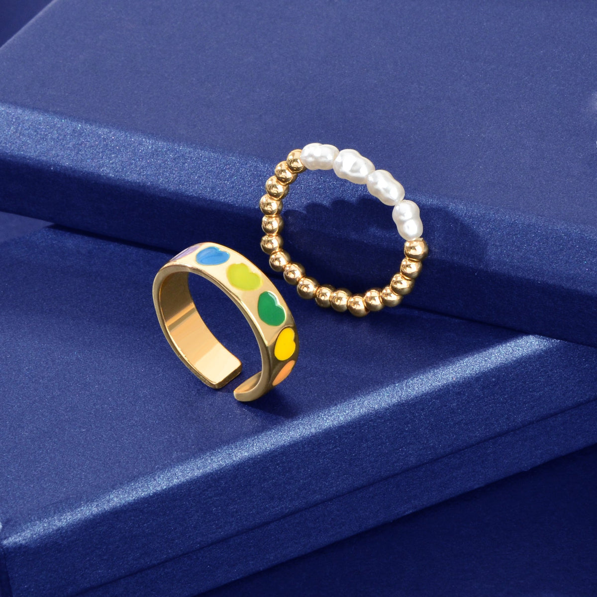 Set of pearl and gold-tone bead elastic heart rings, multicolor enamel and white pearls