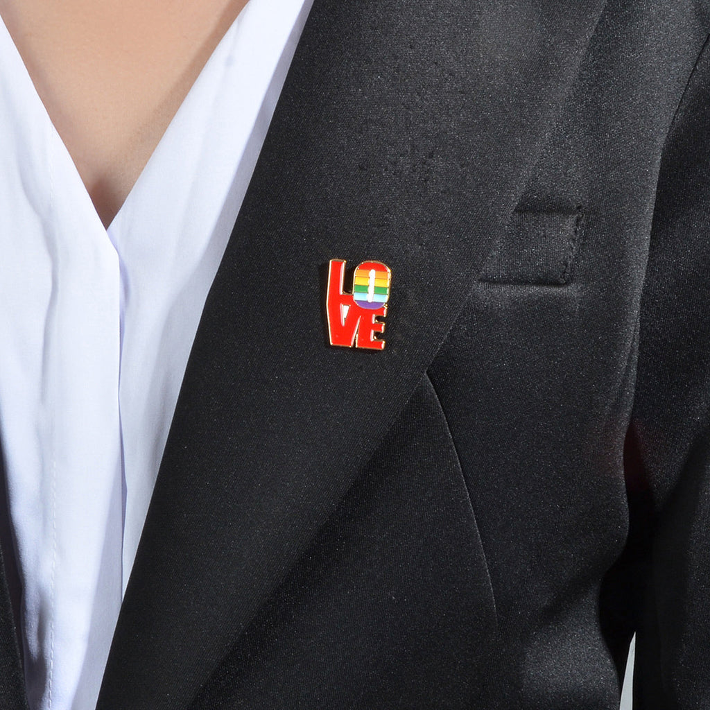 Red enamel LOVE letter brooch pin with rainbow heart letters on black jacket lapel