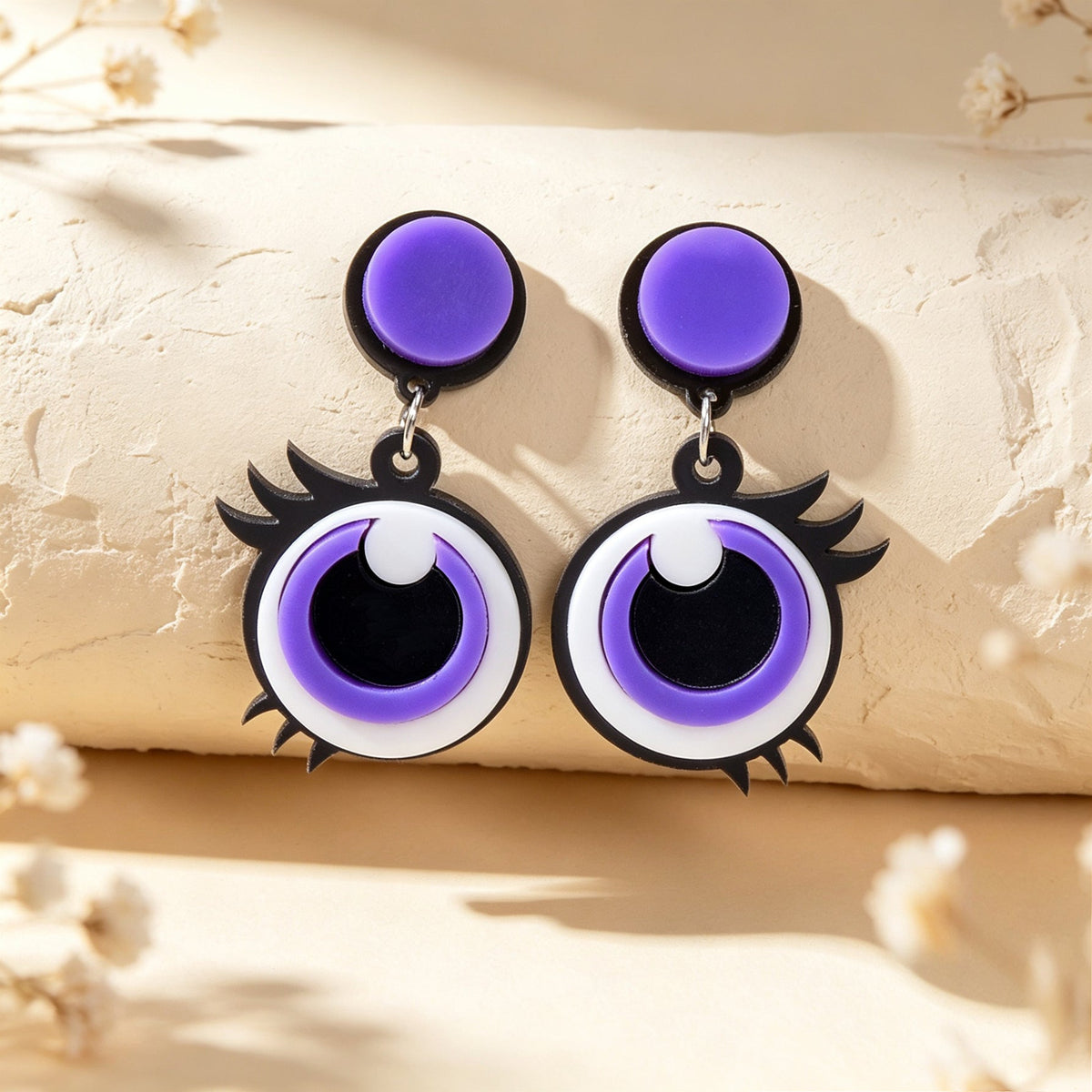 Pair of purple cartoon big-eye dangle earrings, round eye with black pupil and white shine