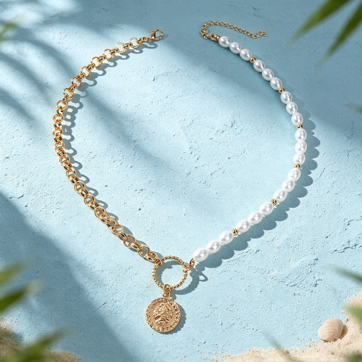 Layered gold-tone chain and faux pearl necklace with round coin pendant