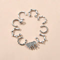 Silver ear cuff set with rhinestones, pearl-like beads, and one spiky charm
