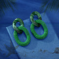 Green resin hoop and textured chain-link drop earrings, front view of oval rings