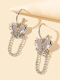 Silver hoop earrings with layered heart charms and dangling chain links
