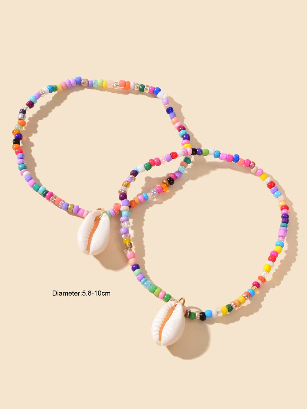 Two multicolor beaded ankle bracelets with white cowrie shell charms