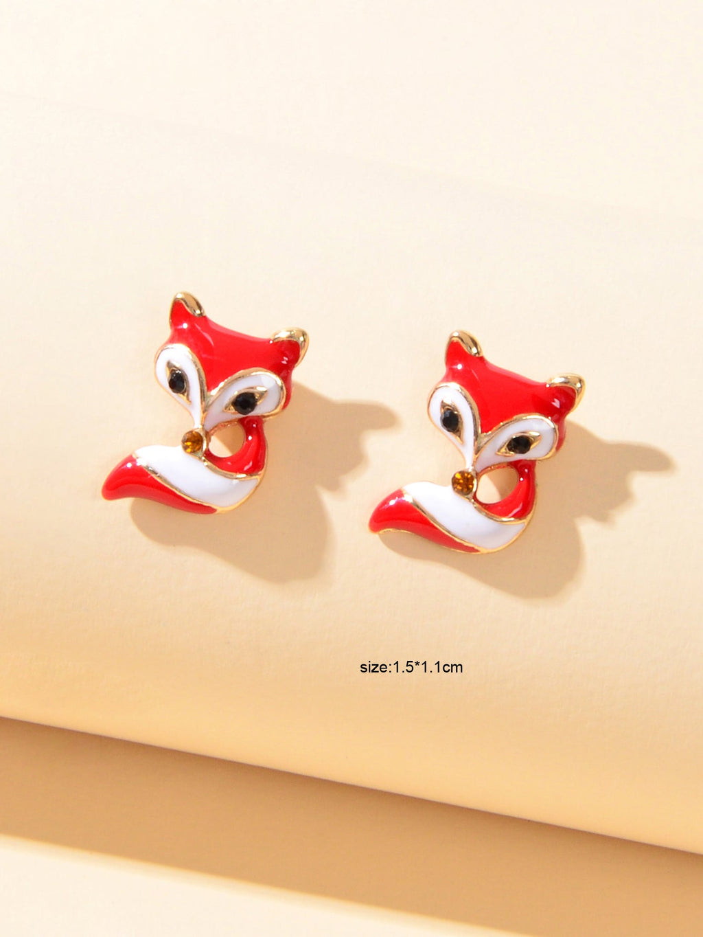 Red and white fox enamel stud earrings with size markings, gold-tone posts