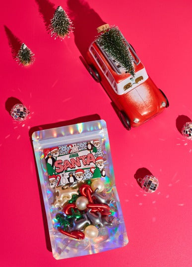 Santa toy set with clear pouch, red sleigh car figurine, and checkered baubles