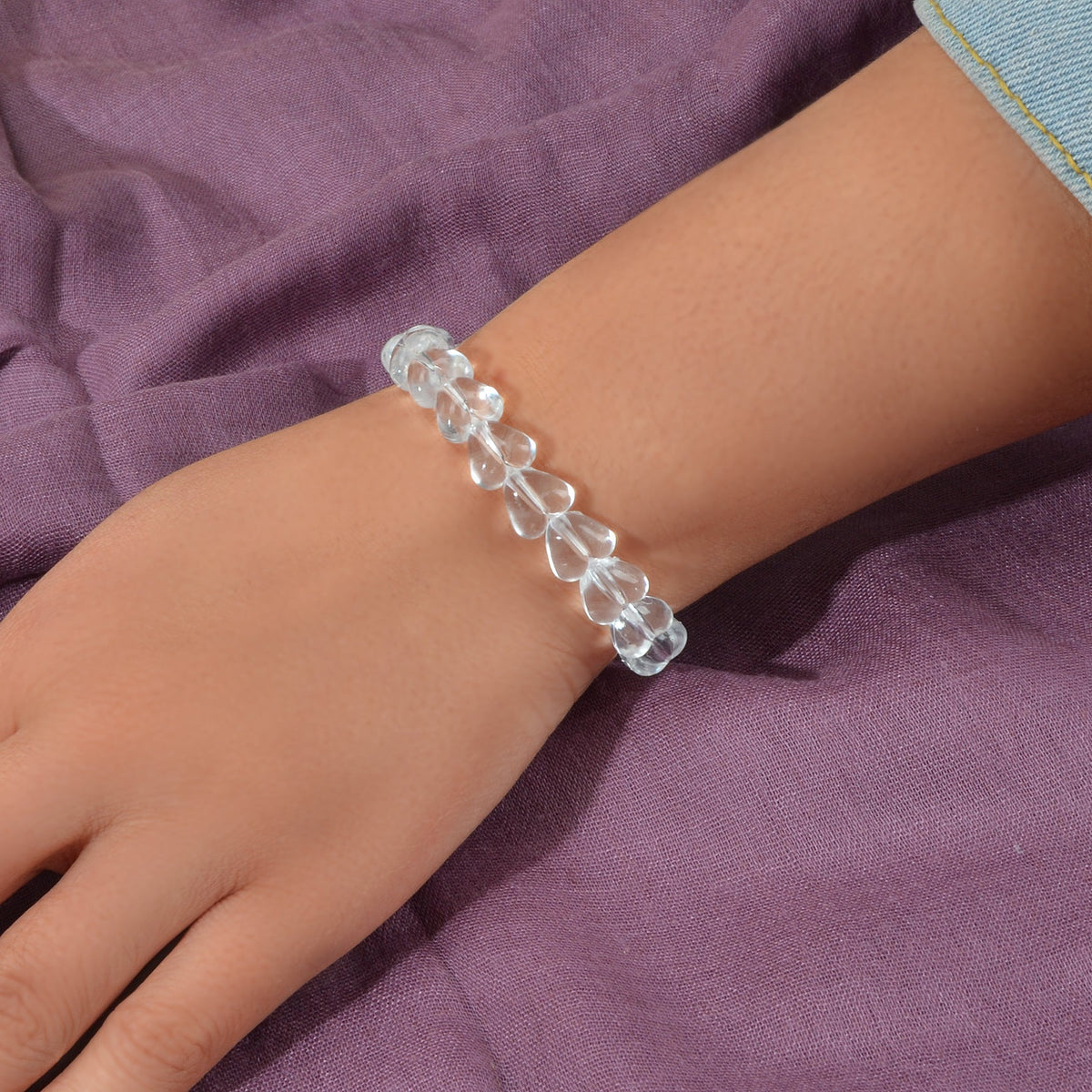 Clear heart-bead elastic bracelet on wrist, transparent resin heart beads