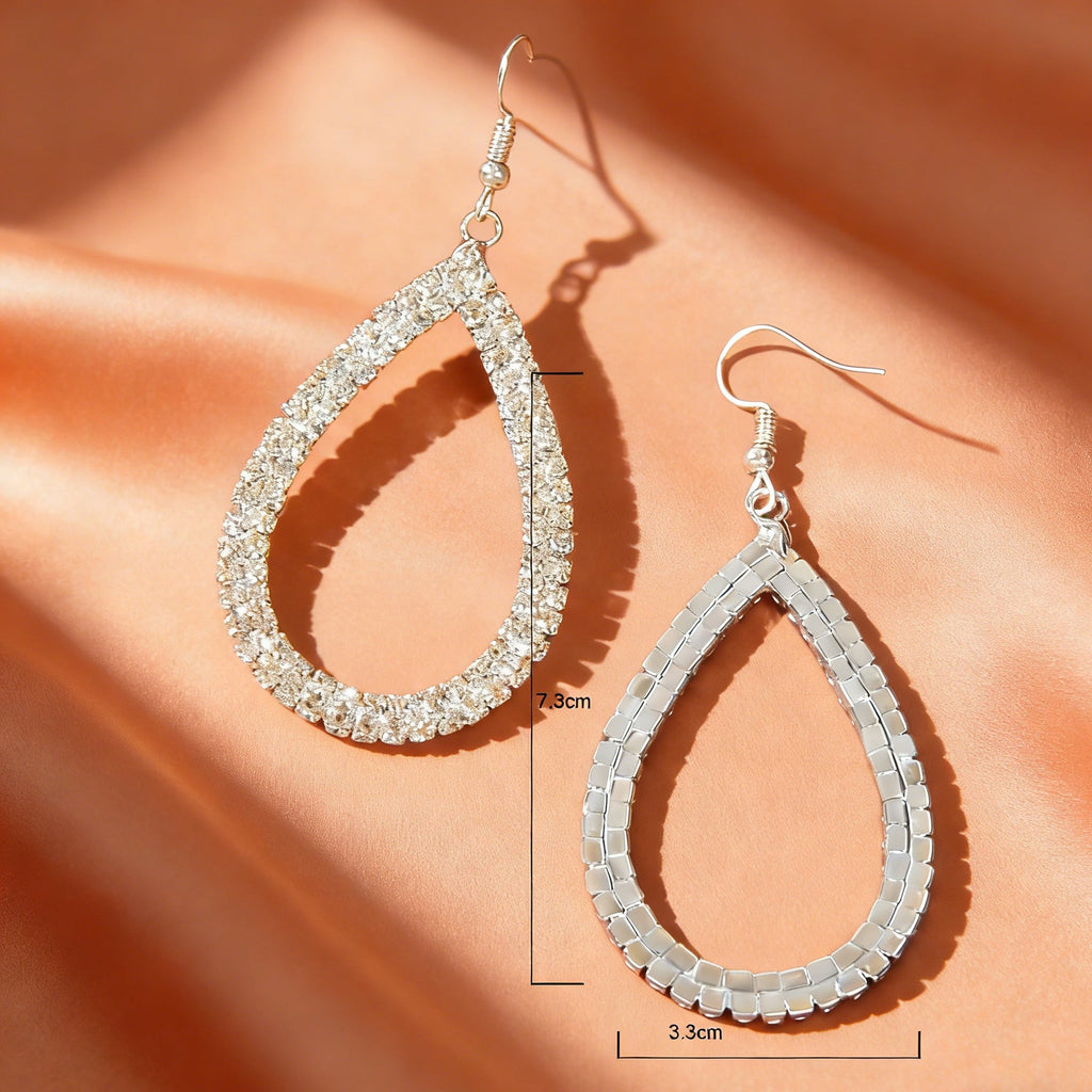 Silver teardrop drop earrings, one crystal pavé and one smooth silver