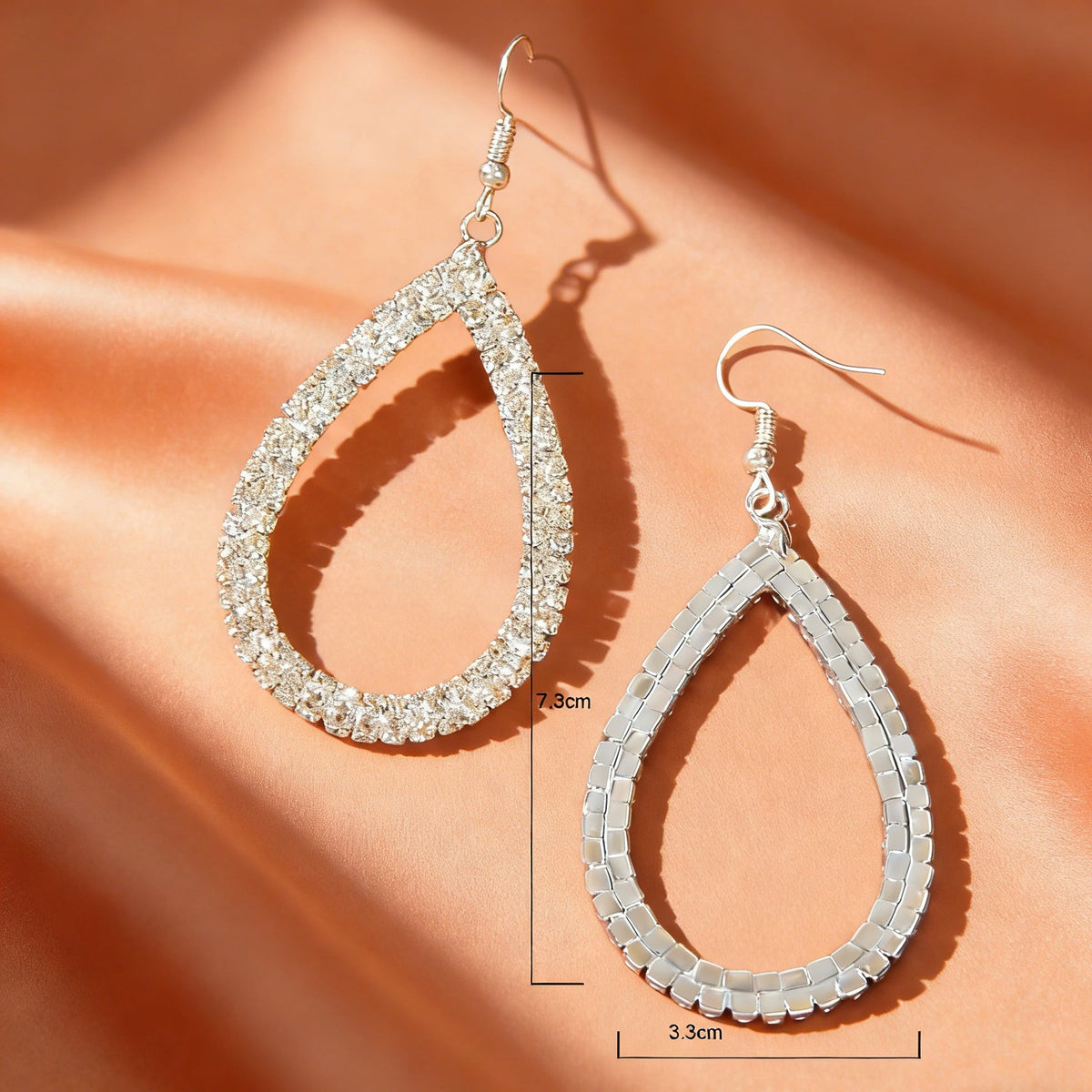 Silver teardrop drop earrings, one crystal pavé and one smooth silver