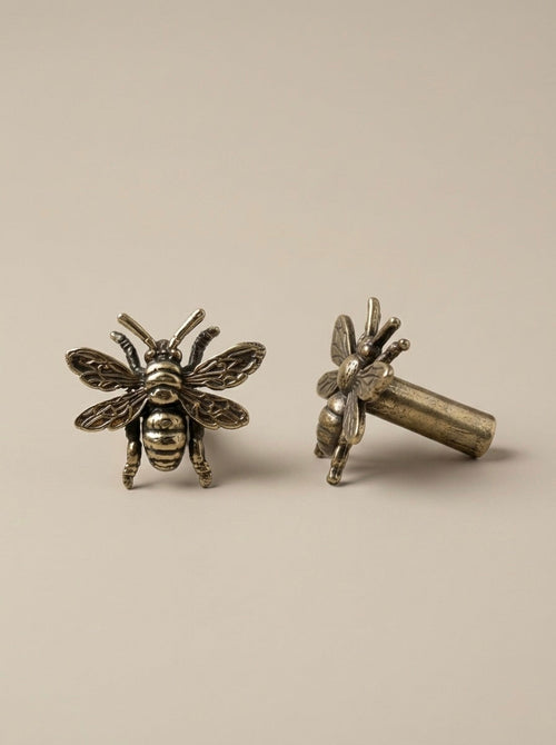 Antique brass bee drawer knobs, one showing cylinder mounting post