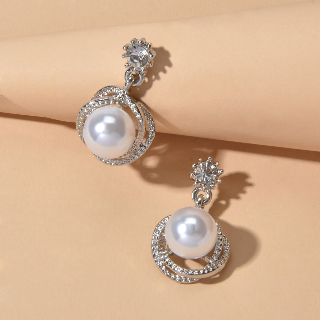 Silver-tone round pearl drop earrings with rhinestone halo and flower-like stud