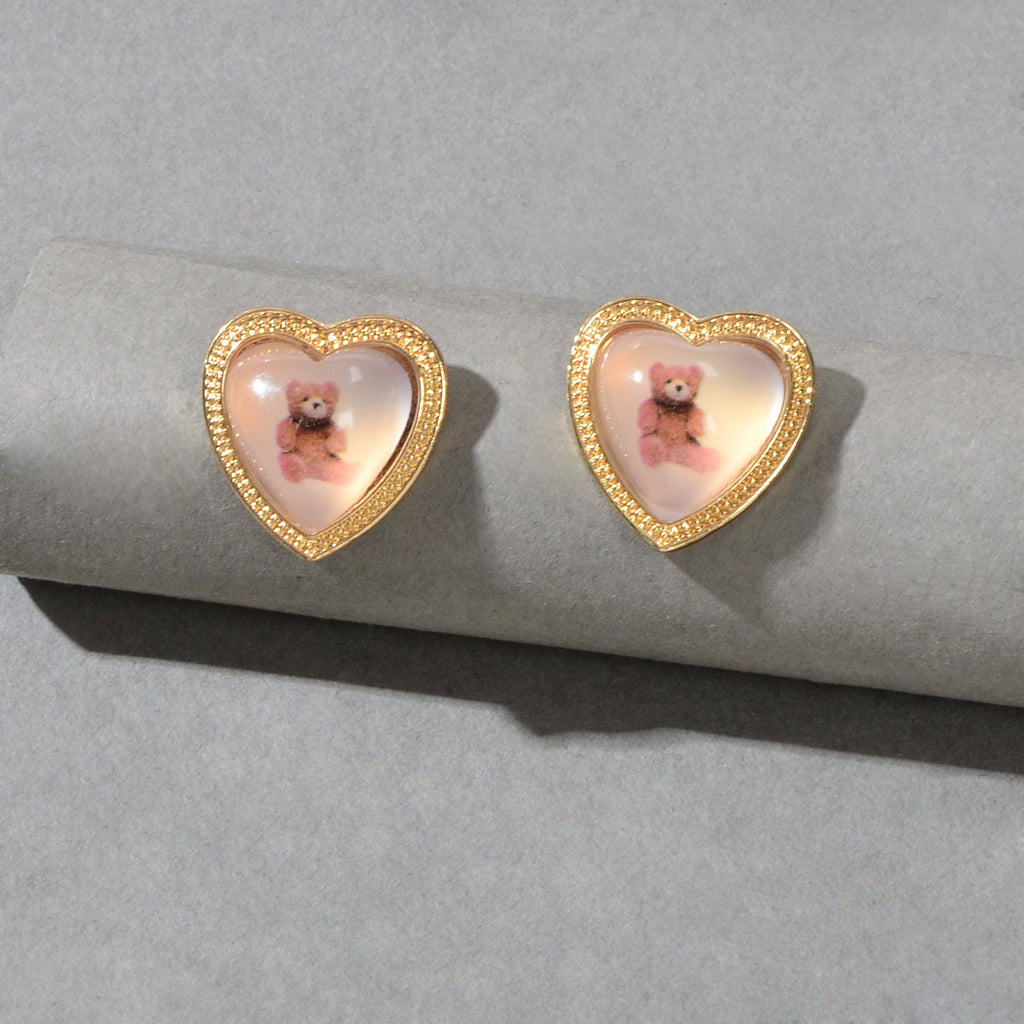 Pair of gold heart resin stud earrings with pink bear scene