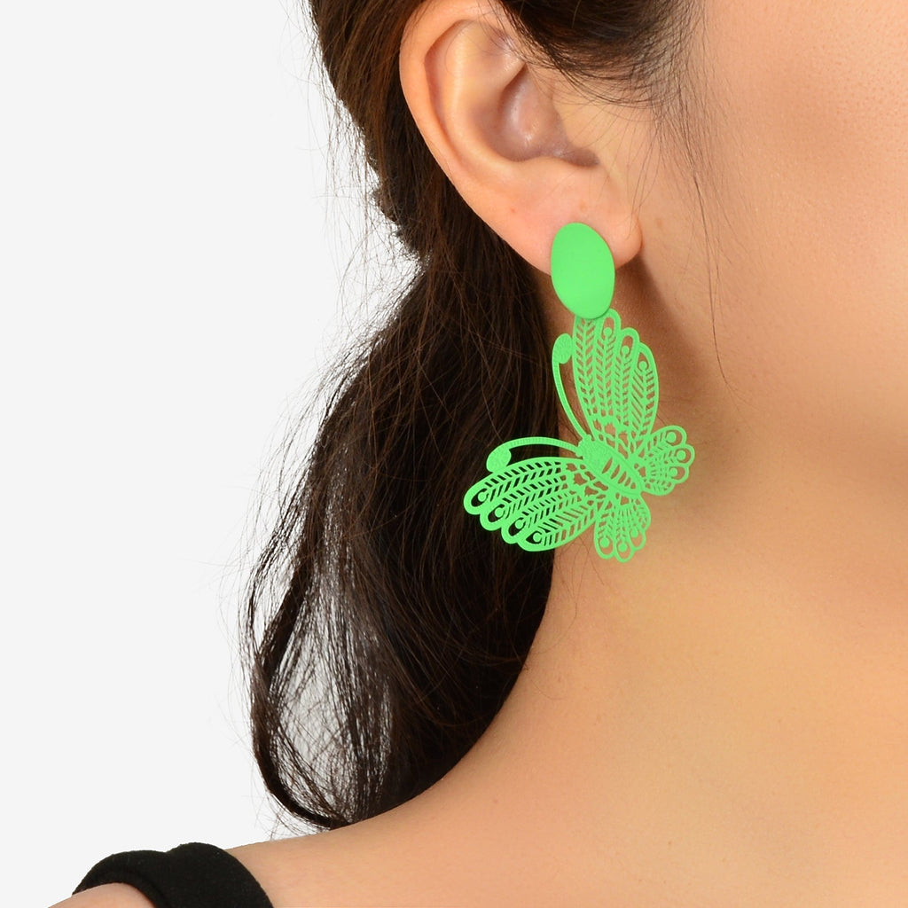 Green hollow butterfly stud earrings with leaf-cutout charm, worn on ear