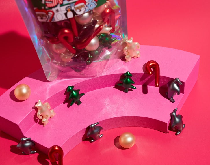 Santa figurine set with clear pouch and assorted red, green, gold, and dark pieces
