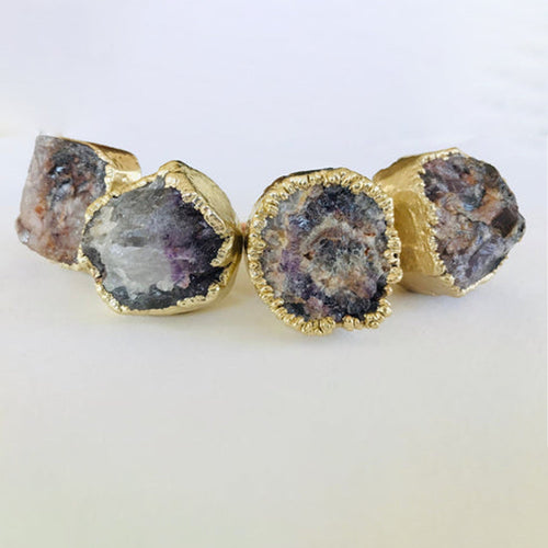 Gold-tone cabinet drawer pulls with amethyst geode stone in gold bezel
