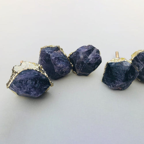 Four amethyst crystal drawer knobs with gold-tone caps and rough dark-purple facets