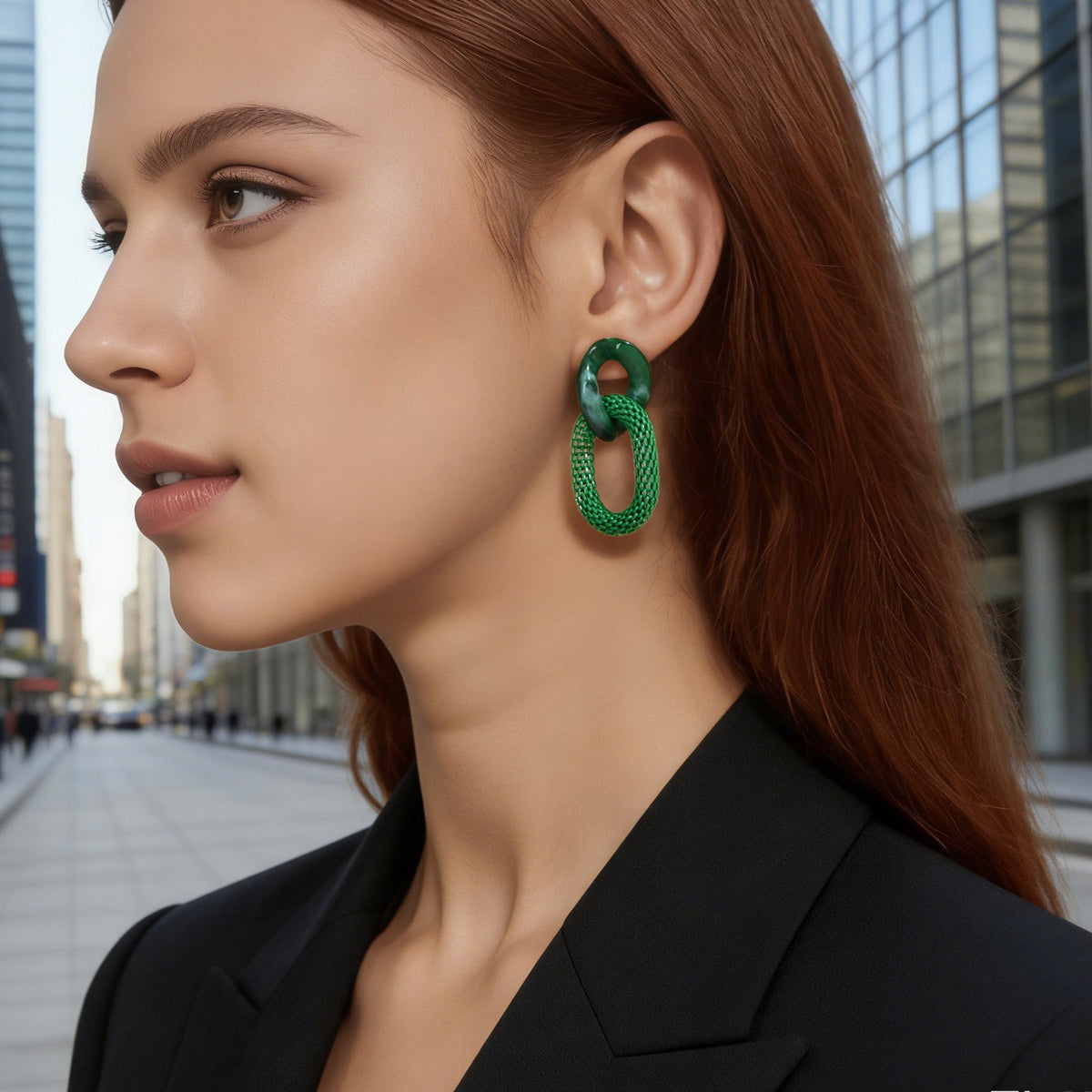 Green chain-link dangling hoop earrings on model, resin oval top loops
