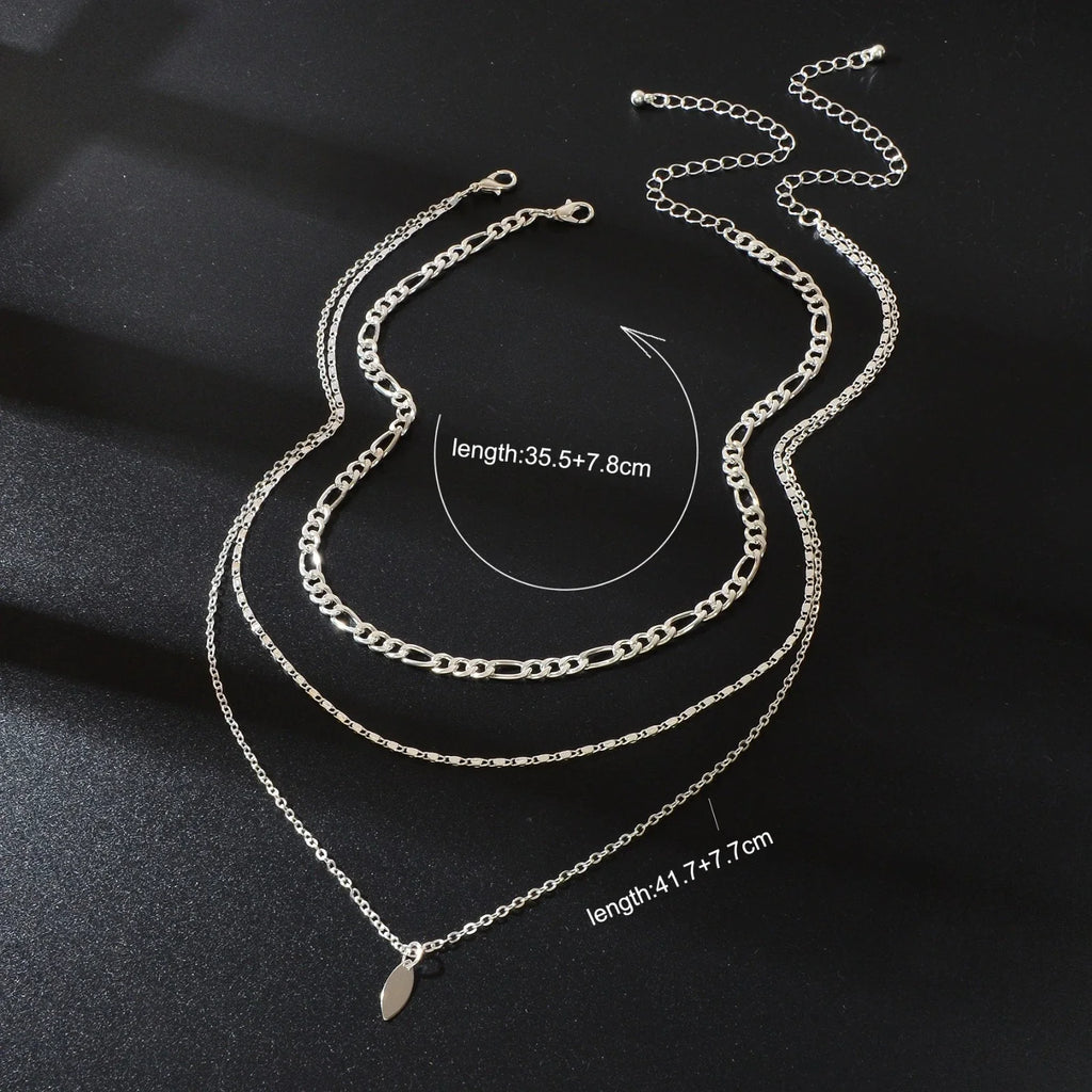 Layered silver-tone choker necklace with leaf-shaped drop charms and three chain strands