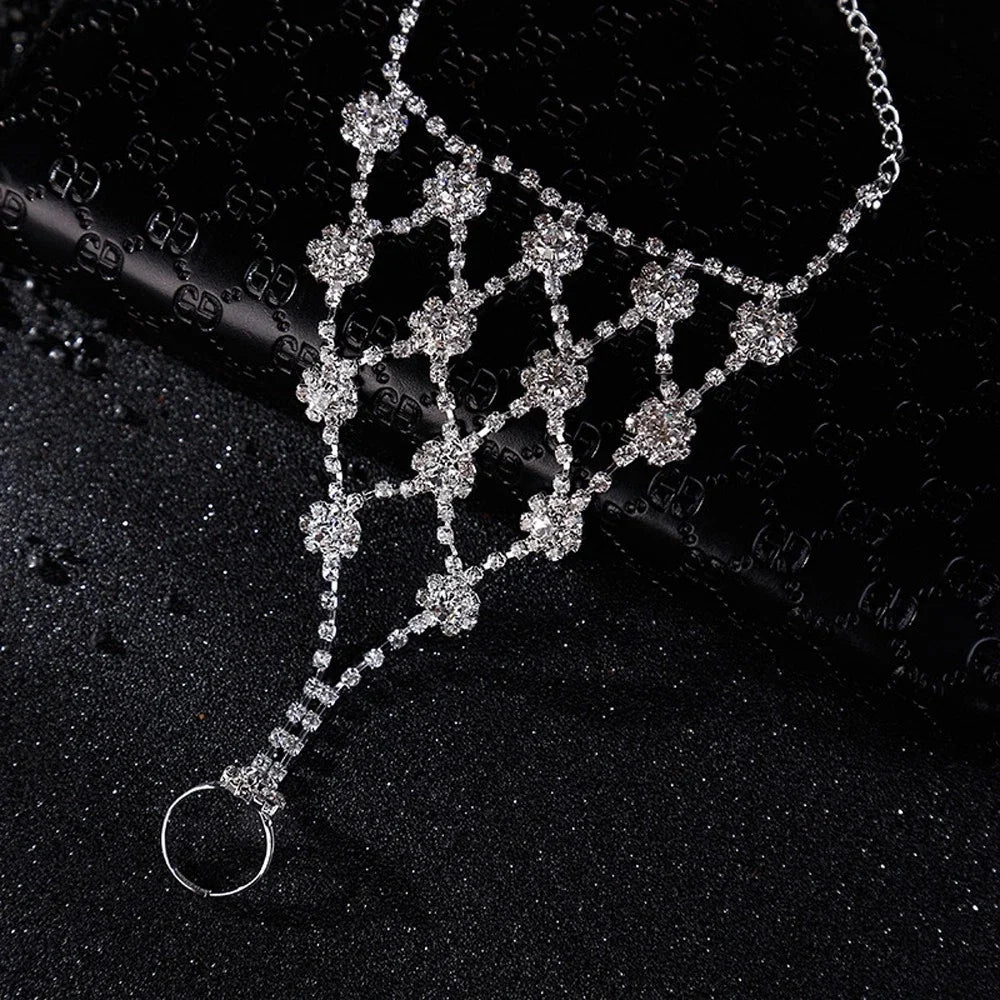 Rhinestone flower bracelet connector with repeating clover motifs and long fringe drop