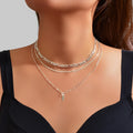 Silver-tone layered choker necklace with stacked chains and teardrop charm pendant