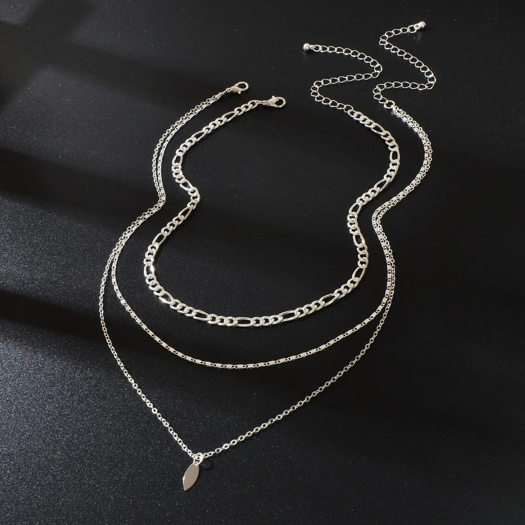 Layered silver-tone choker necklace with leaf drop charms on three chain strands