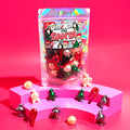 Clear plastic pouch with red and green Santa-themed figurines and tree charms