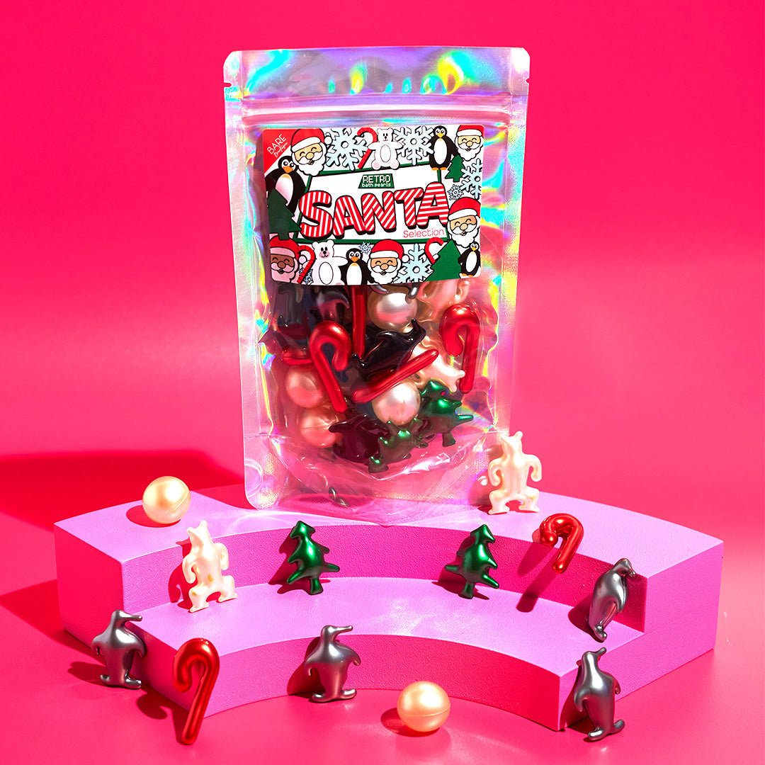 Clear plastic pouch with red and green Santa-themed figurines and tree charms
